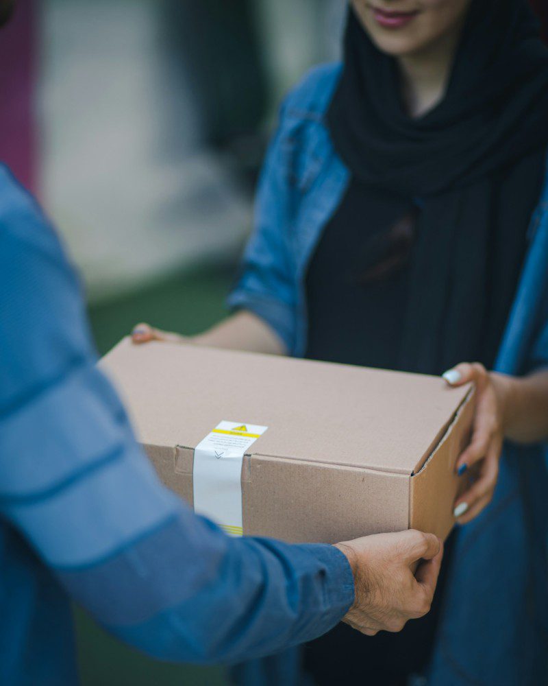 Persona entregando paquete a una mujer de Paack Logistics